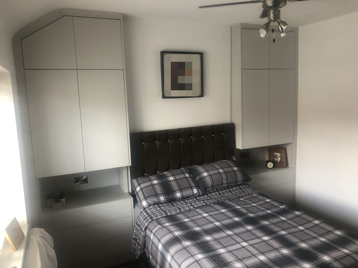 Bespoke fitted bedroom furniture with over-bed storage and bedside units
