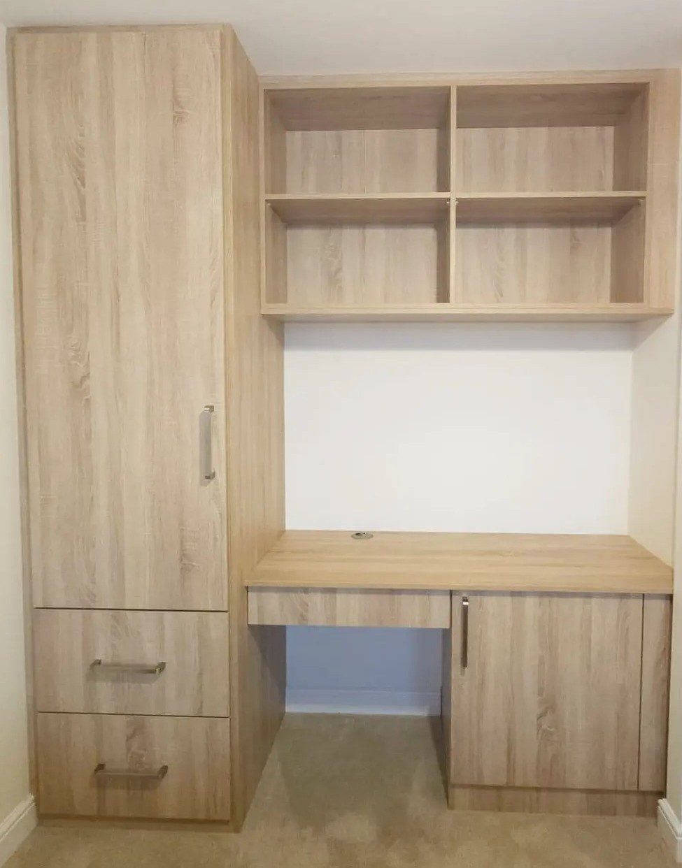 Fitted home office with a bespoke desk and shelving in a study